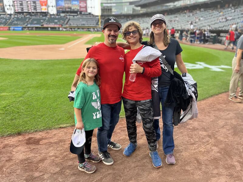 Family smiling together at a ballpark event